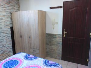 a bedroom with a bed and a wooden door at ESTUDIO FAMILIAR En EZCARAY in Ezcaray