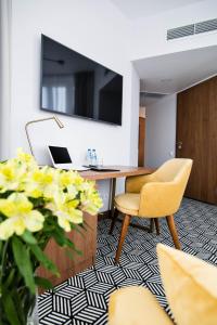 an office with a desk and a chair and flowers at Platinum Residence Boutique in Poznań