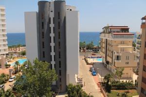 a view of a building with the ocean in the background at Olbia Hotel in Antalya