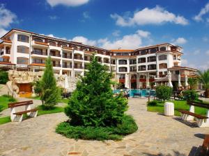 a large building with a christmas tree in front of it at 4* Luxury spa resort - Aheloy, Nessebar, Sunny Beach in Pomorie
