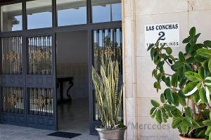 una puerta de un edificio con plantas delante de él en Beautiful Apartment with Balcony and pool., en Torremolinos