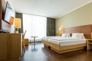 Letto o letti in una camera di Hotel Gasthof Lamm