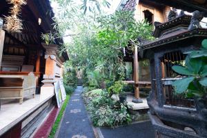 a walkway in front of a building with plants at Jiwa's House in Ubud