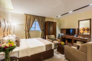 a hotel room with a bed and a television at Al Muhaidb Al Diwan - Al Olaya - Economic in Riyadh