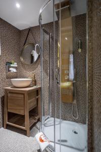 a bathroom with a shower and a sink at Le Temple De Jeanne in Paris