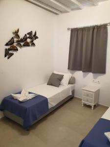 a bedroom with a bed with birds on the wall at Maya Apartments in Dexamenes