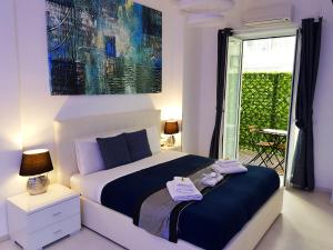 a bedroom with a large bed and a large window at Maschio Angioino Suite - Bed and Breakfast Napoli in Naples