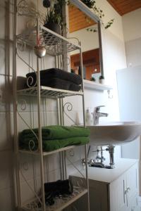 a bathroom with a towel rack next to a sink at Ferienwohnung mit HERZ in Laufenburg in Laufenburg
