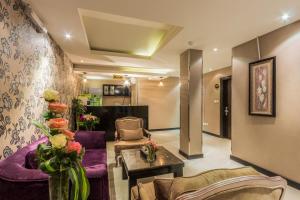 a lobby with a purple couch and chairs and a table at Al Muhaidb Al Diwan - Al Olaya - Economic in Riyadh