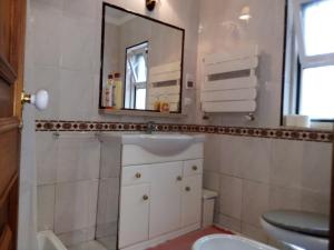 a bathroom with a sink and a mirror at At Home Sintra in Sintra