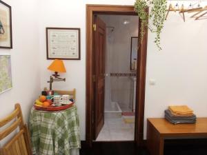 a bathroom with a shower and a door with a table at At Home Sintra in Sintra +15 photos