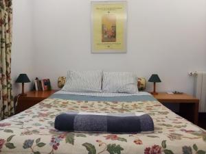 a bedroom with a bed with a blanket on it at At Home Sintra in Sintra