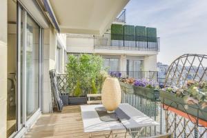 a balcony with a table and chairs on a building at Charming apartment with terrace by Weekome in Paris