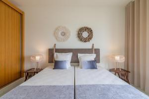 A bed or beds in a room at Fábrica da Ribeira 98 by Destination Algarve