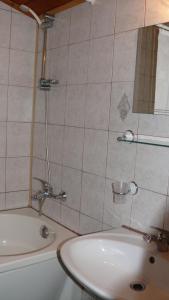 a bathroom with a sink and a bath tub and a sink at Villa Climate Guest House in Varna City