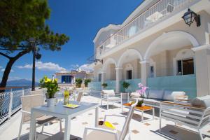 a patio with tables and chairs and a building at Sorrento Dream in Sorrento