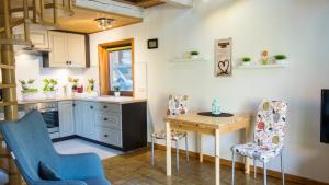 - une cuisine avec une table, deux chaises et un bureau dans l'établissement Ferienhaus Elbtalaue, à Bleckede