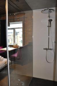 a shower stall in a room with a table at Apartment Arena City Loft in Kyiv +62 photos