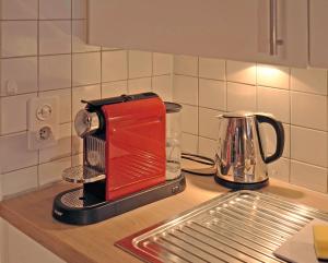 a red toaster sitting on top of a kitchen counter at Haus Fischer, Wohnung Grest in Flumserberg