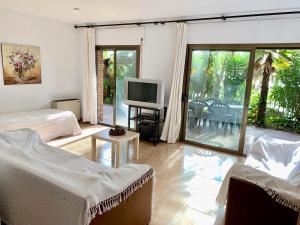 a living room with two beds and a television at APARTAMENTO - WIFI FREE - FRENTE AL MAR in Salou