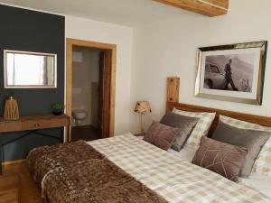 a bedroom with a bed and a picture on the wall at CHALET BELLE KAISER by Belle Stay in Going