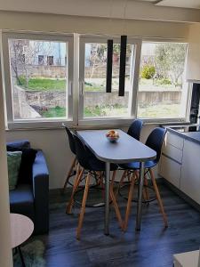 a kitchen and dining room with a table and chairs at Dream Apartments in Split