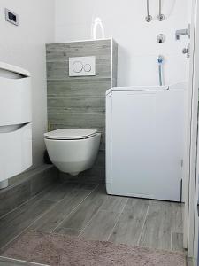 a bathroom with a toilet and a sink at Dream Apartments in Split +17 photos