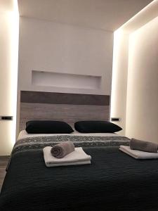 a bedroom with a large bed with towels on it at Dream Apartments in Split