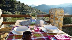 a table with plates and bowls on a table with a view at Casas Rurales Cortijo Leontino in Taberno
