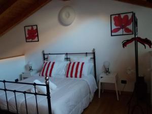 a bedroom with a bed with red and white pillows at Stella Marina 3 in Venice