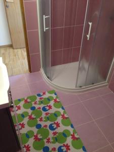 a bathroom with a shower with a shower mat on the floor at Novalja City Central Apartments in Novalja +41 photos