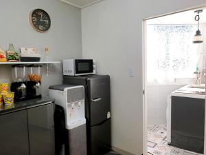 a kitchen with a black refrigerator and a microwave at Y.ROAD 135 in Seoul +42 photos