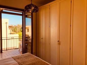 a bedroom with a sliding door to a balcony at Appartamento Senia in San Vito lo Capo