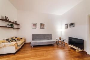 a living room with a couch and a tv at Manzoni House in Bari
