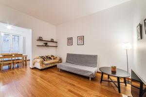 a living room with a couch and a table at Manzoni House in Bari