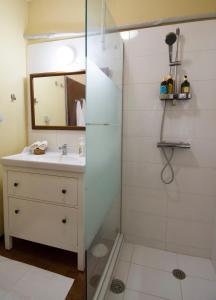 a bathroom with a sink and a shower at THE BOUCAMVIGLIA BEACH HOUSE in Saronida