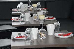 a table with plates and cups and utensils on it at Home-Nr-5 in Roßwein