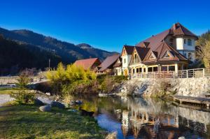 a house on the side of a river at Apartments Povh in Ljubno