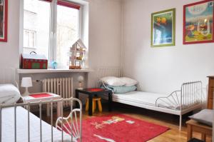 a small room with two beds and a window at Garncarska 7 - 2BR by Homeprime in Krakow