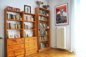 a room with a dresser and book shelves filled with books at Garncarska 7 - 2BR by Homeprime in Krakow