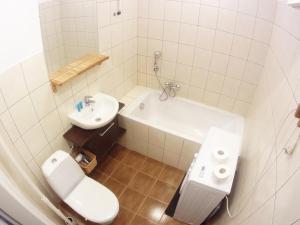 a white bathroom with a toilet and a sink at Garncarska 7 - 2BR by Homeprime in Krakow