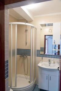 a bathroom with a shower and a sink at Ivona 2 in Sveti Stefan