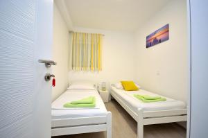 a room with two beds and a window at The Nikolic Suites - Villa Wögenstein in Tribunj
