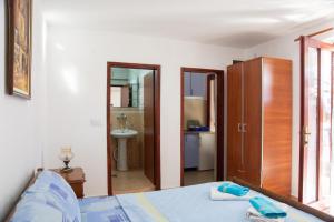 a bedroom with a bed and a bathroom at Ivona 2 in Sveti Stefan