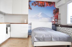 a bedroom with a bed and a mountain mural at Os. 2 pułku 26 - studio by Homeprime in Kraków