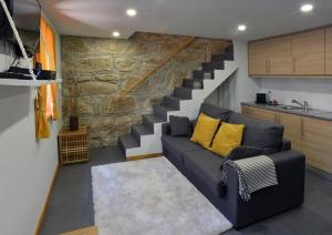 a living room with a couch and a staircase at Oporto Memory Houses 7 in Porto