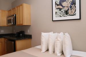a hotel room with a bed with white pillows at Stylish Downtown Studio in the South End, C. Ave #1 in Boston