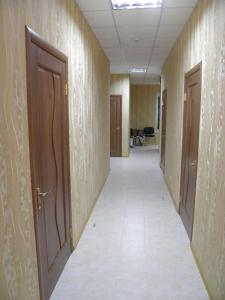 an empty hallway of an office with two doors at Atrium Hotel in Melitopol