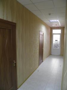 an empty hallway with two doors and a tile floor at Atrium Hotel in Melitopol