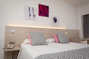 Postel nebo postele na pokoji v ubytování Hotel Timor